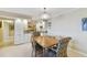 Bright dining area with wood table and chairs, adjacent to kitchen at 10355 Paradise Blvd # 702, Treasure Island, FL 33706