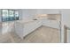 Modern kitchen with white cabinets, marble island, and gold fixtures at 3030 W Santiago St # 4, Tampa, FL 33629