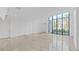 Spacious living area with floor to ceiling windows and light tile floors at 3030 W Santiago St # 4, Tampa, FL 33629