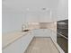 Modern white kitchen with marble countertops and stainless steel appliances at 3030 W Santiago St # 4, Tampa, FL 33629