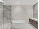 Luxurious bathroom with soaking tub, marble walls, and walk-in shower at 3030 W Santiago St # 4, Tampa, FL 33629