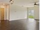 Bright living room with dark hardwood floors and sliding glass doors at 2110 Purple Orchid Pl, Ruskin, FL 33570