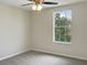 Bedroom with ceiling fan and window overlooking trees at 2110 Purple Orchid Pl, Ruskin, FL 33570