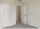 Bright bedroom with double door closet and access to another room at 2110 Purple Orchid Pl, Ruskin, FL 33570