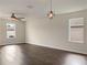 Bright living room with dark hardwood floors and ceiling fan at 2110 Purple Orchid Pl, Ruskin, FL 33570