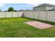 Backyard with grassy area and brick patio at 2110 Purple Orchid Pl, Ruskin, FL 33570