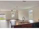 Kitchen with island, sink, and view into living room at 2110 Purple Orchid Pl, Ruskin, FL 33570