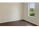 Simple bedroom with dark hardwood floors and a large window at 2110 Purple Orchid Pl, Ruskin, FL 33570