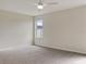Spacious bedroom with neutral walls, carpeted floors, and a large window at 2110 Purple Orchid Pl, Ruskin, FL 33570