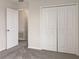 Bright bedroom with double door closet and access to another room at 2110 Purple Orchid Pl, Ruskin, FL 33570