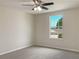 Bedroom with ceiling fan and window with a view at 2110 Purple Orchid Pl, Ruskin, FL 33570
