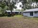 Backyard view showing a freshly painted house with a shed at 504 Maydell Dr, Tampa, FL 33619