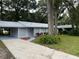 Newly painted house with a carport and well-maintained lawn at 504 Maydell Dr, Tampa, FL 33619