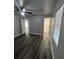 Spacious bedroom with wood-look floors and ceiling fan at 504 Maydell Dr, Tampa, FL 33619