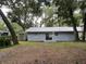 Backyard view showing a freshly painted house with a shed at 504 Maydell Dr, Tampa, FL 33619