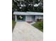 Newly renovated home with a carport and landscaped yard at 504 Maydell Dr, Tampa, FL 33619
