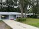 Newly painted house with a carport and well-maintained lawn at 504 Maydell Dr, Tampa, FL 33619