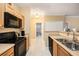 Updated kitchen with stainless steel appliances and view of bathroom at 5000 Culbreath Key Way # 1-212, Tampa, FL 33611