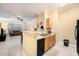 Open kitchen with island, stainless steel appliances, and light wood cabinets at 5000 Culbreath Key Way # 1-212, Tampa, FL 33611