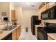 Modern kitchen with stainless steel appliances and light wood cabinets at 5000 Culbreath Key Way # 1-212, Tampa, FL 33611