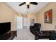 Home office with a ceiling fan, built-in shelving and a view of the hallway at 5000 Culbreath Key Way # 1-212, Tampa, FL 33611