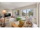 Living room with futon, large window, and access to balcony at 2358 Ecuadorian Way # 56, Clearwater, FL 33763