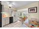 Galley kitchen with white cabinets, appliances, and breakfast nook at 2358 Ecuadorian Way # 56, Clearwater, FL 33763