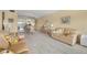 Bright living room with plush sofa and view into dining area at 2358 Ecuadorian Way # 56, Clearwater, FL 33763