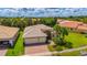 Aerial view of a single Gathering home with a large yard and driveway at 4963 Sapphire Sound Dr, Wimauma, FL 33598