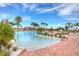 Freeform pool with a shallow end and plenty of lounge chairs at 4963 Sapphire Sound Dr, Wimauma, FL 33598