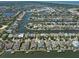 Aerial view of a waterfront neighborhood featuring homes along canals, boat docks, and scenic waterways at 415 Islebay Dr, Apollo Beach, FL 33572