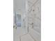 Clean bathroom with white tile and marble shower features a combined bathtub and shower head combo at 415 Islebay Dr, Apollo Beach, FL 33572