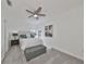 Cozy bedroom featuring a soft gray color palette, ceiling fan, and a decorative bed with accent pillows at 415 Islebay Dr, Apollo Beach, FL 33572