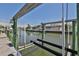 A close-up of the waterfront boat lift with a home view in the background, ready for boating enthusiasts at 415 Islebay Dr, Apollo Beach, FL 33572