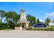 An entrance to the MiraBay community, featuring well-maintained landscaping and a decorative tower at 415 Islebay Dr, Apollo Beach, FL 33572