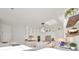 Spacious white kitchen features a large island, stainless steel appliances, and contemporary hanging light fixtures at 415 Islebay Dr, Apollo Beach, FL 33572