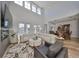 Open-concept living room with high ceilings, modern furnishings, and a view into the dining area at 415 Islebay Dr, Apollo Beach, FL 33572