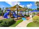 Well-maintained playground with slides, canopies, and a gazebo in a landscaped setting at 415 Islebay Dr, Apollo Beach, FL 33572