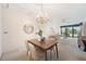 Elegant dining room with chandelier and view into living room at 50 Coe Rd # 224, Belleair, FL 33756