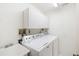 Laundry room with washer, dryer, and utility sink at 50 Coe Rd # 224, Belleair, FL 33756