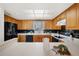 Bright kitchen features wood cabinets, black appliances, and ample counter space at 50 Coe Rd # 224, Belleair, FL 33756