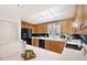 Bright kitchen features wood cabinets, modern appliances, and a skylight at 50 Coe Rd # 224, Belleair, FL 33756