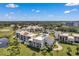 Aerial view of condo community near golf course and water at 50 Coe Rd # 224, Belleair, FL 33756
