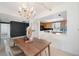 Bright dining room with wood table, chandelier, and kitchen view at 50 Coe Rd # 224, Belleair, FL 33756