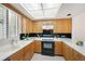 Kitchen with wood cabinets, and modern appliances at 50 Coe Rd # 224, Belleair, FL 33756