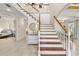 Elegant staircase with white railings and wooden steps at 11302 Southwind Lake Dr, Gibsonton, FL 33534