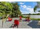 Relaxing lakeside firepit with red Adirondack chairs at 11302 Southwind Lake Dr, Gibsonton, FL 33534
