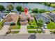 Aerial view of a house, highlighting its location by the lake at 11302 Southwind Lake Dr, Gibsonton, FL 33534
