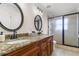 Bathroom boasts granite countertops, double sinks, and a large glass shower at 11302 Southwind Lake Dr, Gibsonton, FL 33534