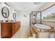Elegant bathroom with double vanity, soaking tub, and walk-in shower at 11302 Southwind Lake Dr, Gibsonton, FL 33534